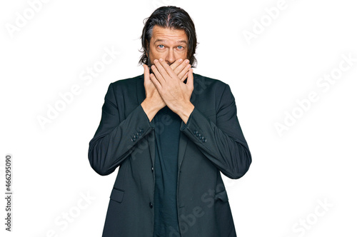 Middle age handsome man wearing business clothes shocked covering mouth with hands for mistake. secret concept.