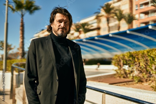 Wallpaper Mural Middle age businessman smiling happy standing at the city. Torontodigital.ca