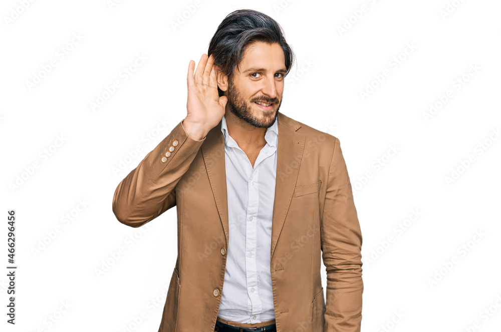 Young hispanic man wearing business clothes smiling with hand over ear listening an hearing to rumor or gossip. deafness concept. Young hispanic man wearing business clothes smiling with hand over ear listening an hearing to rumor or gossip. deafness concept.