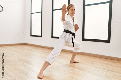 Young caucasian woman smiling confident training karate at sport center