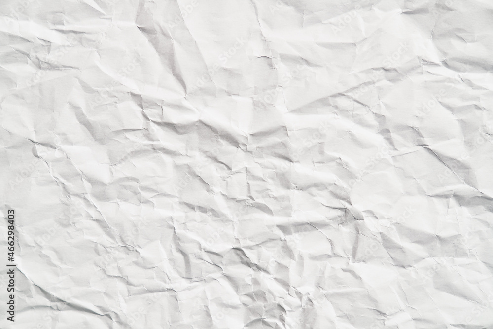 Fototapeta premium White crumpled paper texture with wrinkles. Damaged and torn sheet