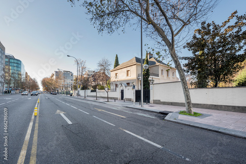 Avenue in the city of Madrid with beautiful single-family homes and office buildings with glass facades