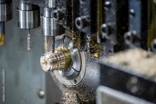 The multi-tasking CNC lathe machine tapping the brass fitting parts.