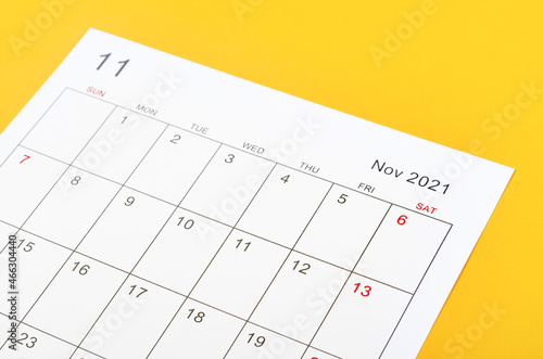November 2021 calendar sheet on yellow background. © gamjai