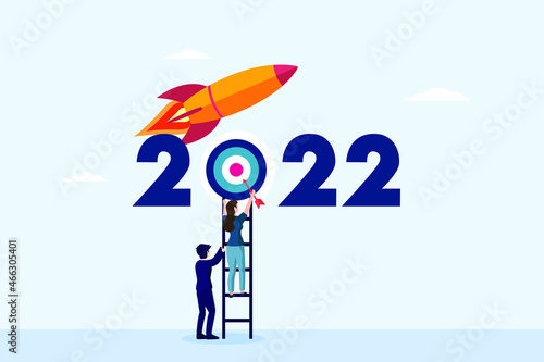 New year target vector concept. Two business people aiming a dart to target while using a ladder with 2022 numbers and rocket background