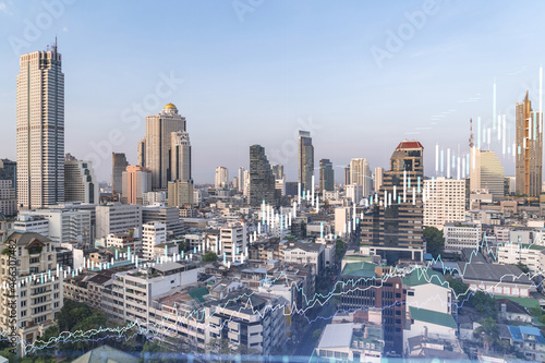 Financial stock chart hologram over panorama city view of Bangkok  business center in Southeast Asia. The concept of international transactions. Double exposure.