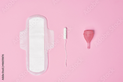 hygienic feminine tampon for menstruation  menstrual cup  pad on pink background