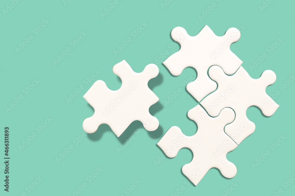 White jigsaw puzzle on green background, Find the right joined team work and fit correctly concept White jigsaw puzzle on green background, Find the right joined team work and fit correctly concept