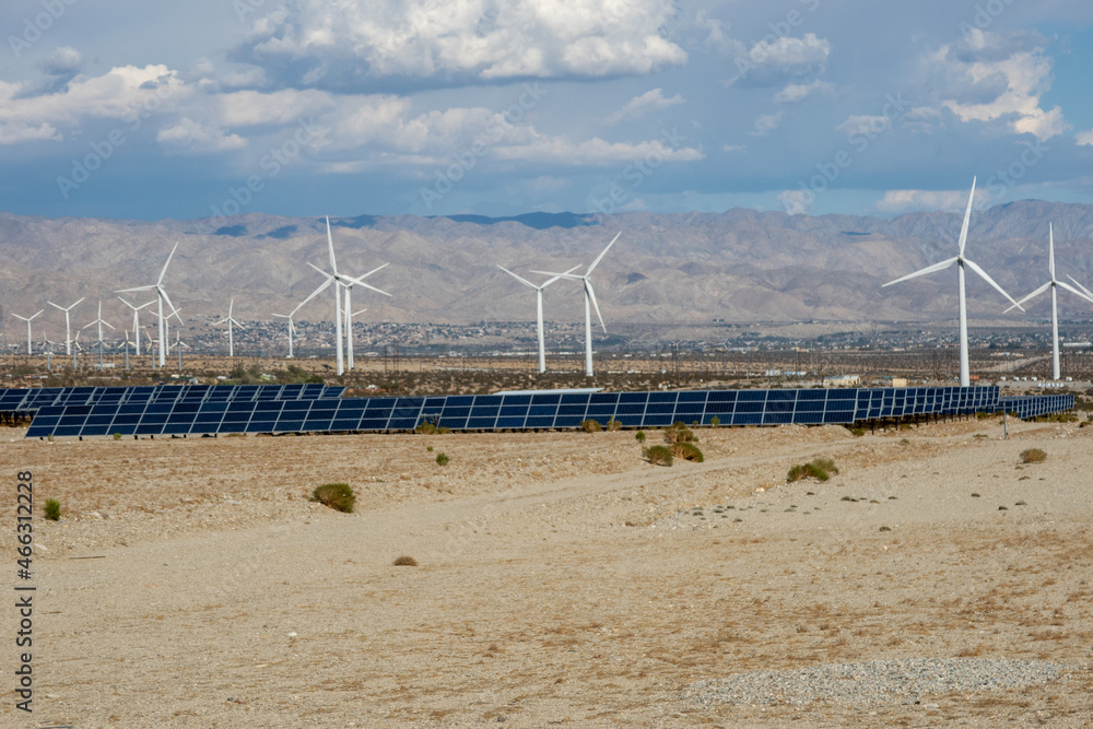 An Energy Farm Center with Photovoltaic Solar Panels and a Dynamo Generator Wind Farm Making Renewable Electricity