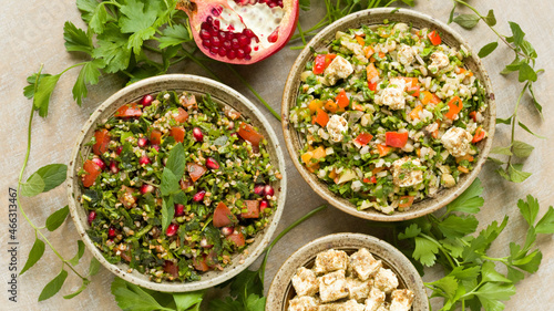 Typical Tabbouleh salad with parsley and other tabbouleh style salad with barley and feta. Top view.