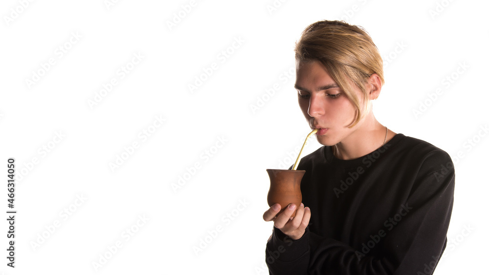 A young attractive guy with beautiful eyes drinks a drink. A young attractive guy with beautiful eyes drinks a drink.