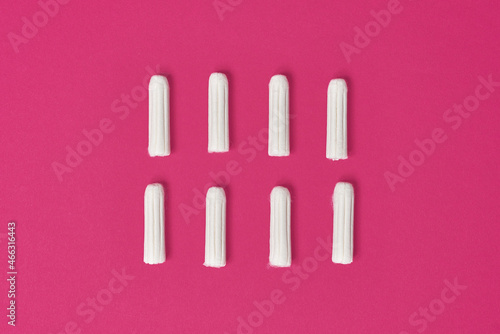 hygienic feminine tampons for menstruation on a pink fuchsia background
