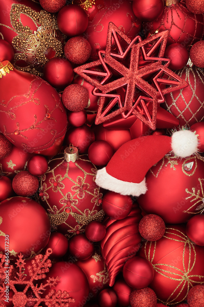 Christmas santa hat, luxury red and gold tree bauble decorations. Abstract Xmas background composition for the festive season. Top view. Christmas santa hat, luxury red and gold tree bauble decorations. Abstract Xmas background composition for the festive season. Top view.