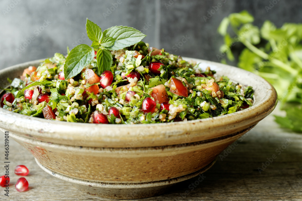 Tabbouleh salad with parsley, mint, bulgur and pomegranate. Fresh salad with herbs. Tabbouleh salad with parsley, mint, bulgur and pomegranate. Fresh salad with herbs.