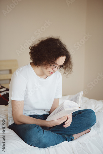 Teenage boy reading book.