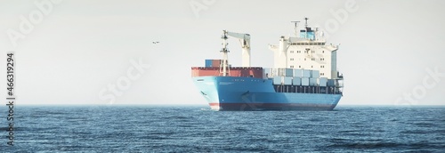 Fotografie, Obraz Large blue cargo container ship with a crane sailing in an open sea