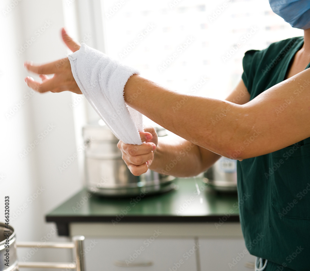 Female doctor washing hands before operation. Female doctor washing hands before operation.