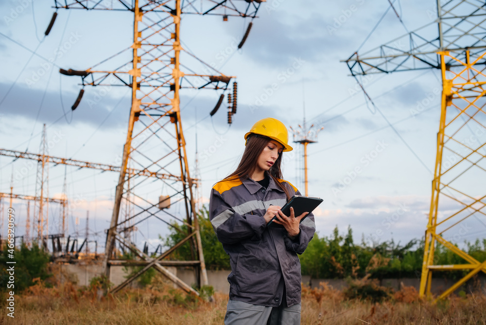 A young engineering worker inspects and controls the equipment of the power line. Energy A young engineering worker inspects and controls the equipment of the power line. Energy