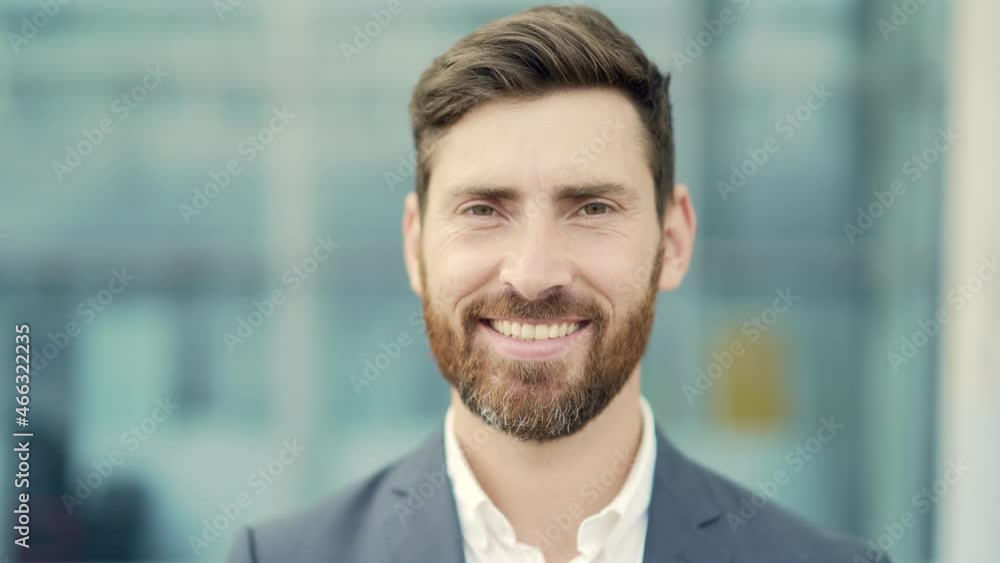 close up portrait happy Bearded Caucasian business man looking at camera outside. Face of smile handsome successful businessman in formal suit on modern urban city street background outdoor closeup close up portrait happy Bearded Caucasian business man looking at camera outside. Face of smile handsome successful businessman in formal suit on modern urban city street background outdoor closeup