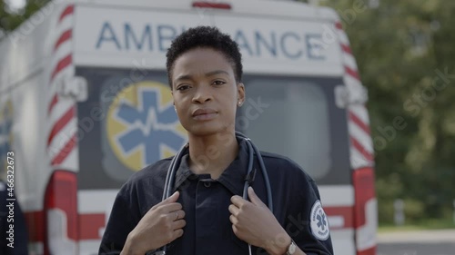 African american female paramedic in uniform posing outdoors