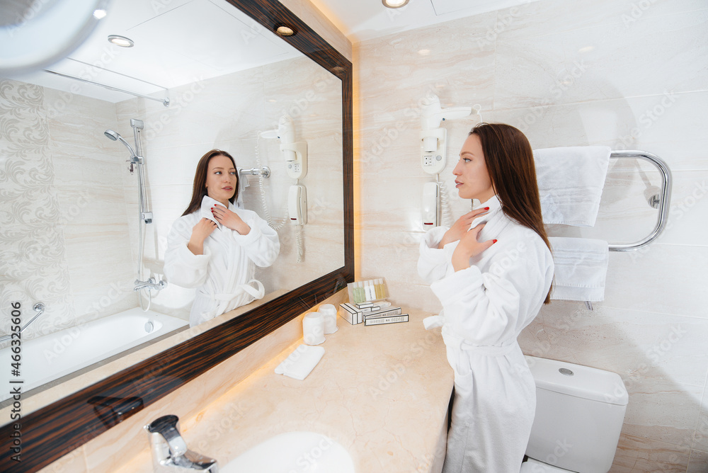 Young beautiful girl in a white beautiful bathroom. Fresh good morning at the hotel. Young beautiful girl in a white beautiful bathroom. Fresh good morning at the hotel.