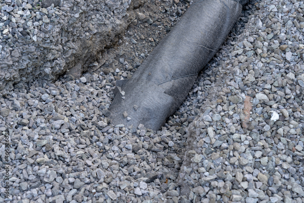 Drainage system pipe, gravel, geotextile. StockFoto Adobe Stock