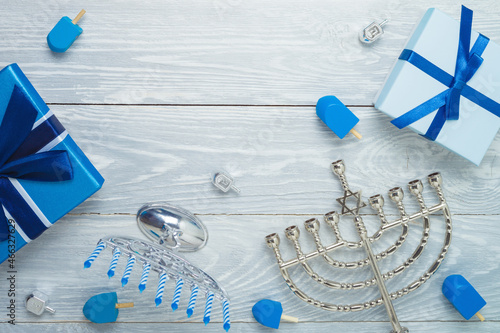 Top view composition design for jewish holiday Hanukkah with menorah and gift box photo