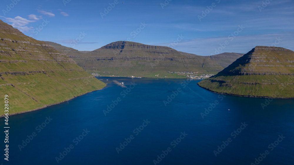 Beautiful aerial view of Sydradalur port and village near the Seal woman statue in the Faroe Islands Beautiful aerial view of Sydradalur port and village near the Seal woman statue in the Faroe Islands