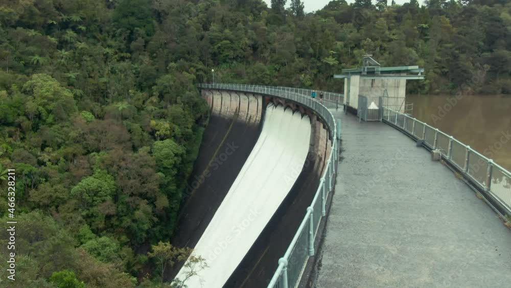 Aerial: Water Reservoir spillway of the Nihotupu Reservoir, overflowing from heavy rain. Auckland, New Zealand Aerial: Water Reservoir spillway of the Nihotupu Reservoir, overflowing from heavy rain. Auckland, New Zealand