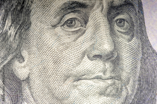 Benjamin Franklin's face in close-up on a US hundred dollar bill.