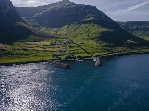 Beautiful aerial view of Sydradalur port and village near the Seal woman statue in the Faroe Islands photo