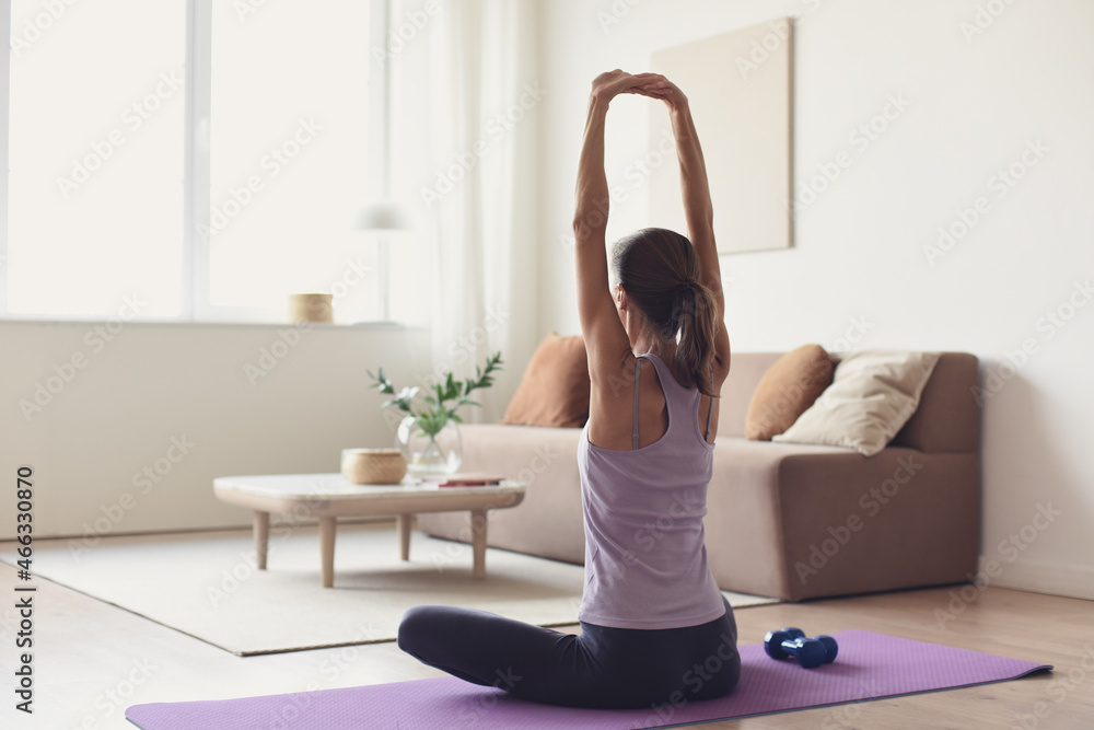 Woman doing fitness exercises at home. Girl training and practicing yoga at home. Harmony, balance, meditation, relaxation, healthy lifestyle, mindfulness concept. Woman doing fitness exercises at home. Girl training and practicing yoga at home. Harmony, balance, meditation, relaxation, healthy lifestyle, mindfulness concept.