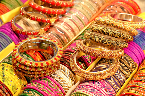 Indian colorful bangles displayed in local shop in a market of Pune, India, These bangles are made of Glass used as beauty accessories by Indian women. photo