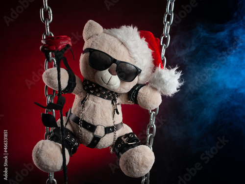 Christmas gift a teddy bear in a Santa Claus hat with a rose - an accessory for BDSM games from a sex shop