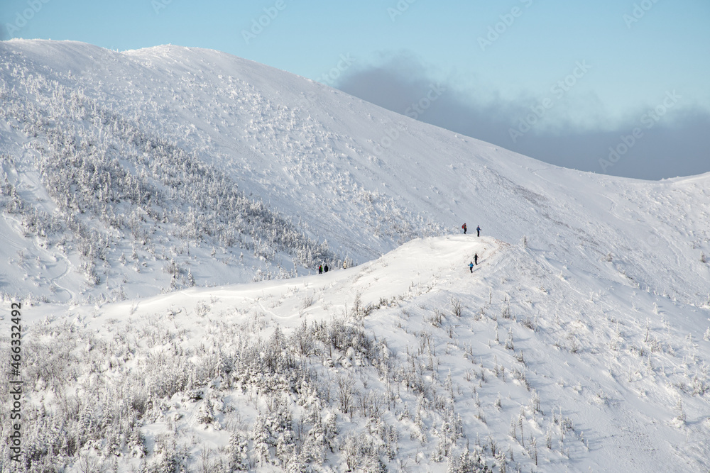People hiking the Vallieres-de-St-Real mountain range during a wonderful winter day, Gaspesie, Quebec, Canada