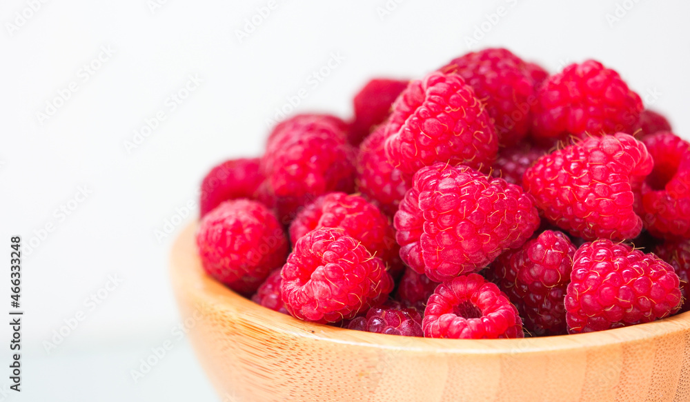 Fresh red raspberry in old wooden plate, copy space Fresh red raspberry in old wooden plate, copy space