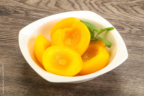 Sweet ripe canned peaches with mint