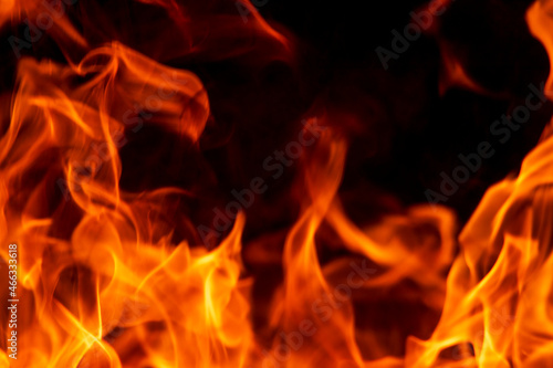 Abstract flame, fire flame texture, background. Blurred moving tongues of fire on a dark background. © Oleksandr Kliuiko