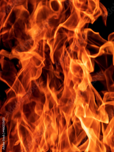 Abstract flame, fire flame texture, background. Blurred moving tongues of fire on a dark background.