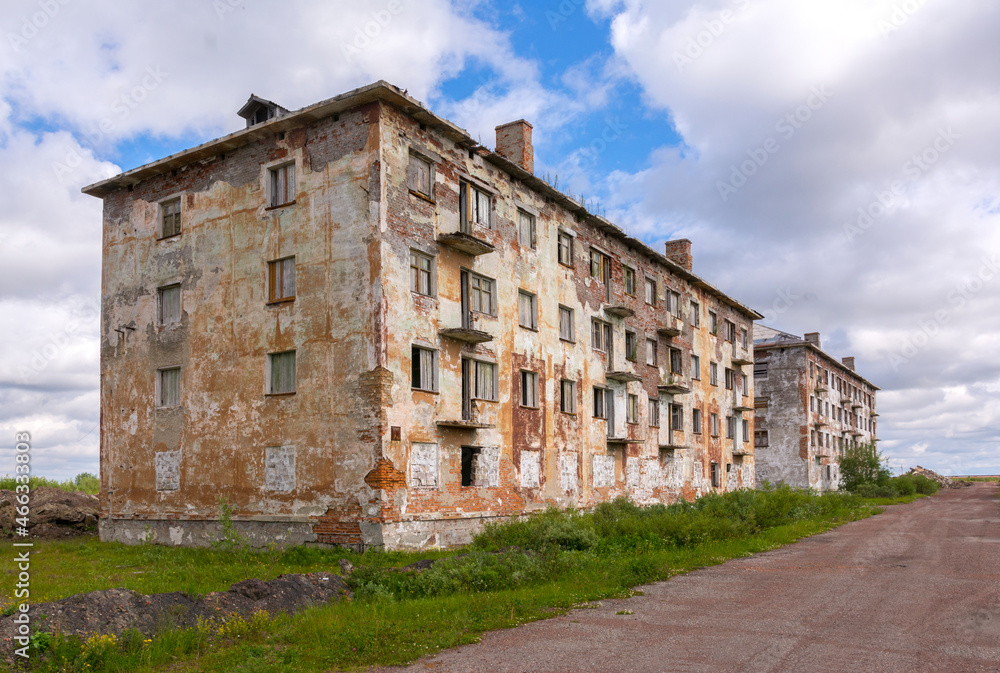 Old brick abandoned multi-storey building in the abandoned settlement of Yurshor, Vorkuta. 