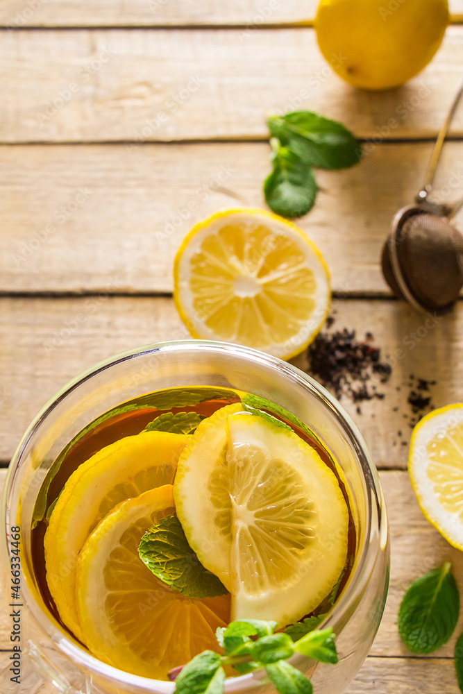 Tea with lemon and mint in transparent cup. Alternative medicine. Hot drink for relaxation. Tea with lemon and mint in transparent cup. Alternative medicine. Hot drink for relaxation.