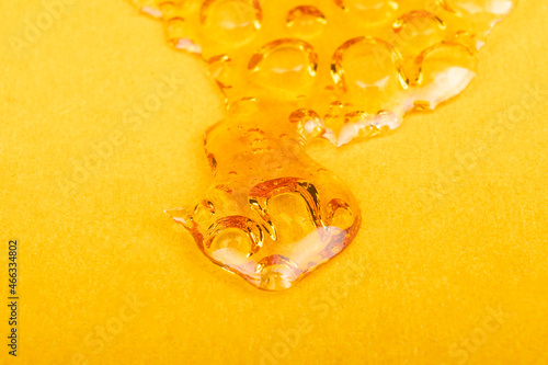 high thc, cannabis wax marijuana concentrate on yellow background macro