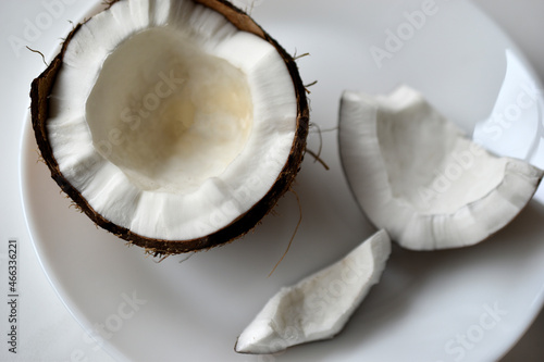 A broken slice of coconut on a plate