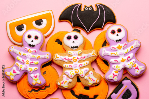 Homemade Halloween cookies  pumpkins  ghosts  bats  skeletons on pink background
