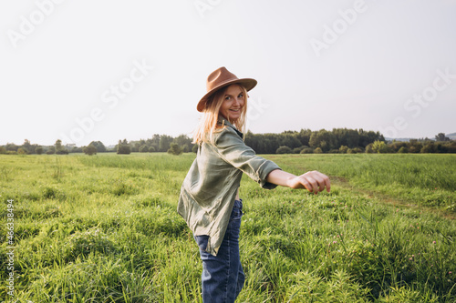 Portrait happy woman enjoying sunset stay on the green grass. Fresh air, Travel, Holidays and Journey concept. Nature banner