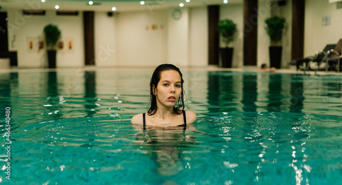 Portrait of beautiful woman in swimwear relaxing in swimming pool spa. © Ivan Zelenin
