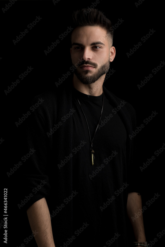 mysterious young guy in casual outfit looking to side mysterious young guy in casual outfit looking to side
