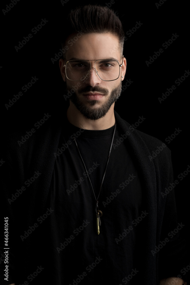 dramatic cool guy wearing eyeglasses and posing in a fashion way dramatic cool guy wearing eyeglasses and posing in a fashion way