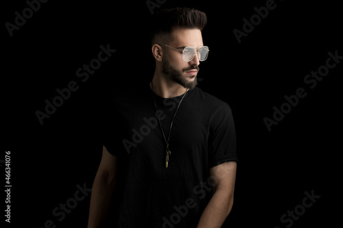 cool bearded man wearing glasses and looking to side