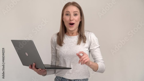 Wow. Surprised happy excited woman looking with amazement into laptop screen, reading shocking news or talking on video call, online communication